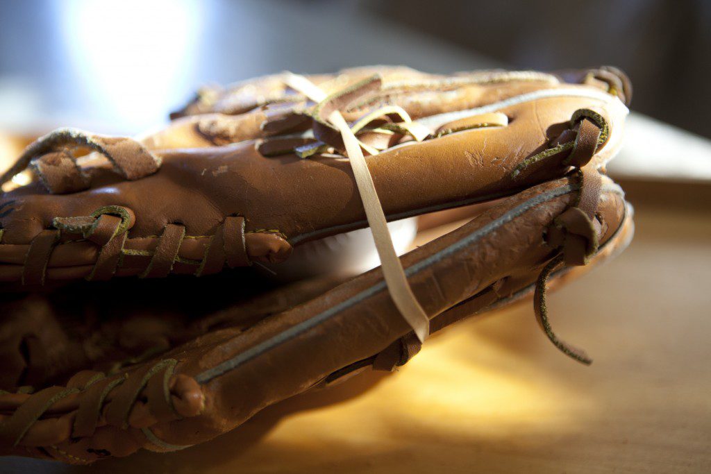 Glove with a ball in it and a rubber band around it.