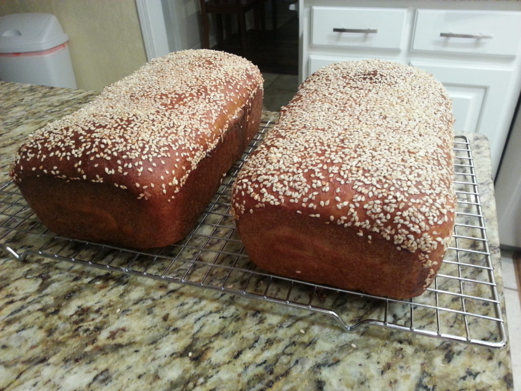 Loaves of honey whole-wheat sesame bread.