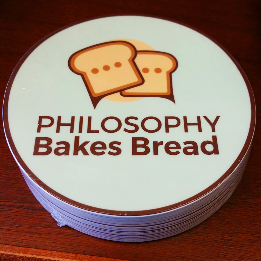 Photo of a sticker featuring the Philosophy Bakes Bread logo. 