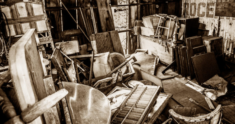 This is an image of a very cluttered space in warm-toned black and white.