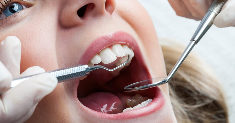 Photo of a young girl in the dentist's chair. Clicking on this image will open the printable Adobe PDF version of the one-sheet document on 'The Ethics of Dentistry.'